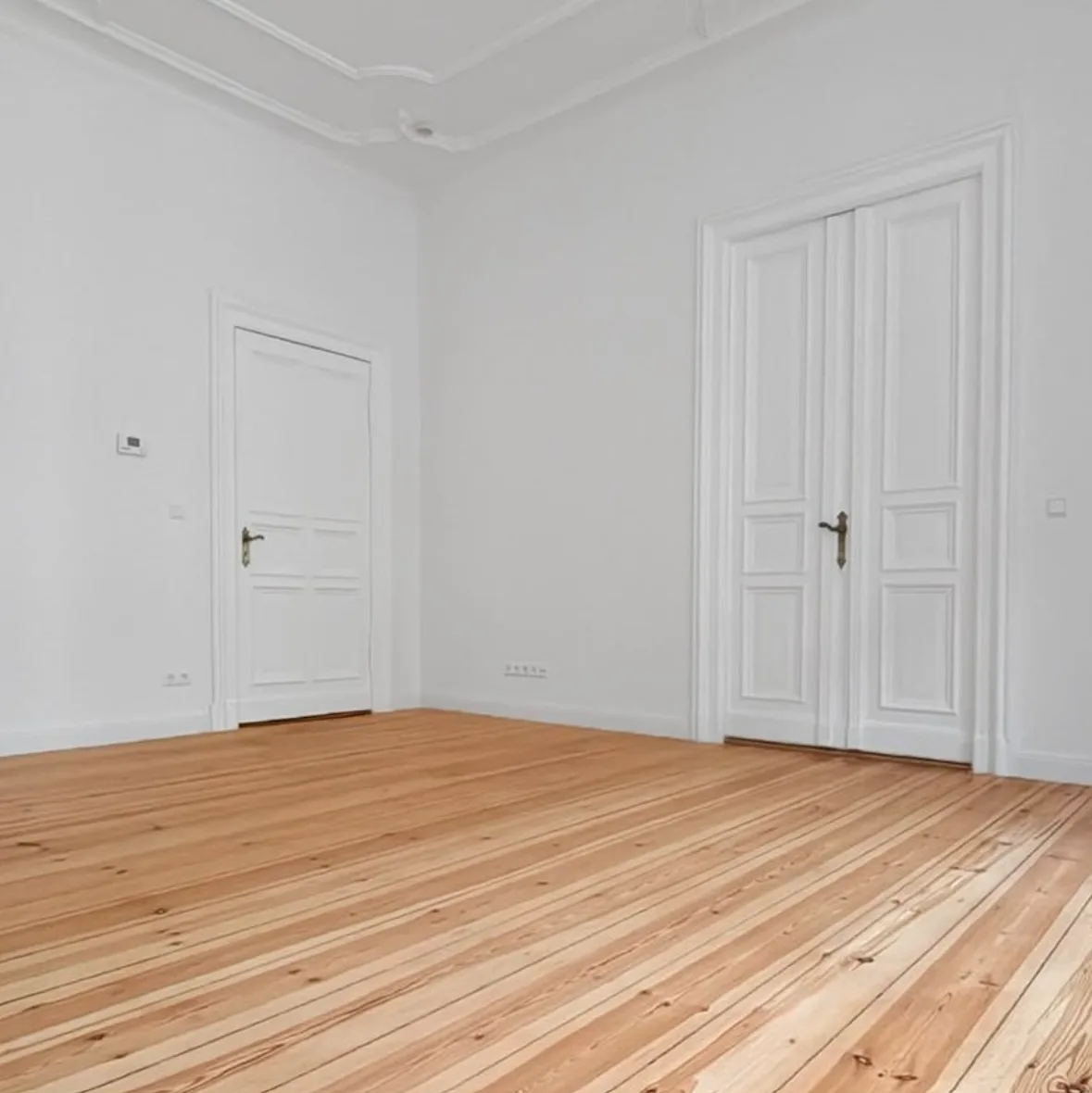 Abgeschliffene Holzdielen und aufgearbeitete Innentüren im zweiten Wohnbereich